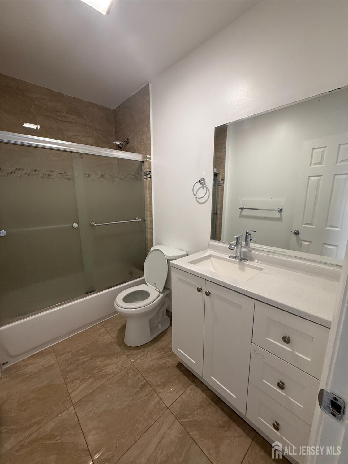 579 Florida Grove Road Perth Amboy, NJ 08861 - Photo 11 of 14 a bathroom with a double vanity sink a toilet and a shower