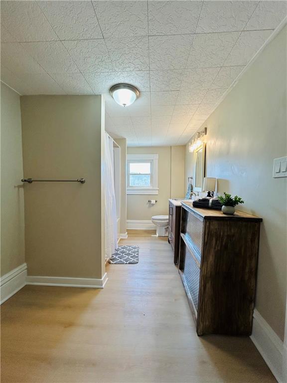 103 Memorial Street Dunbar, PA 15431 - Photo 15 of 29 a view of kitchen and empty room with wooden floor