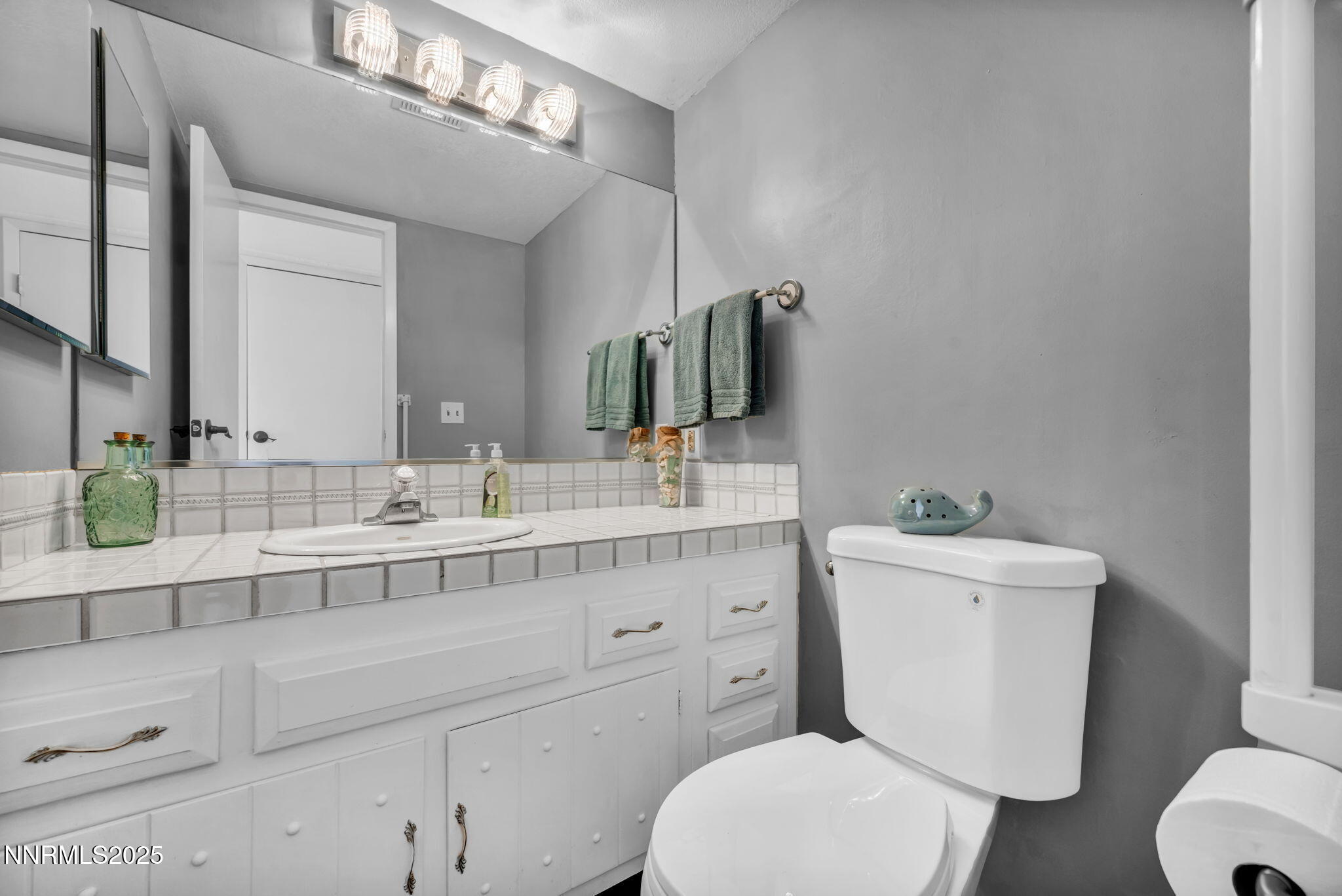 1481 Foster Drive Reno, NV 89509 - Photo 21 of 52 a bathroom with a toilet sink and mirror