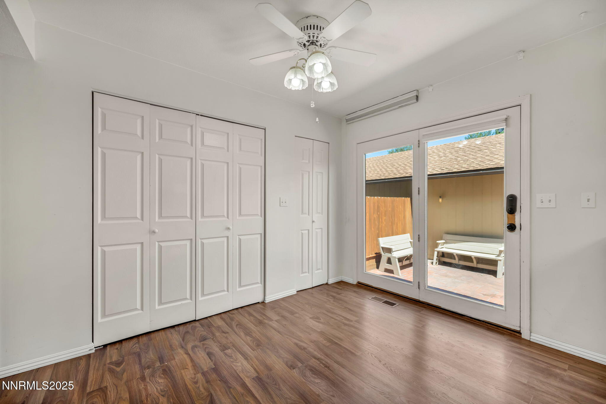 1481 Foster Drive Reno, NV 89509 - Photo 25 of 52 an empty room with wooden floor a ceiling fan and windows
