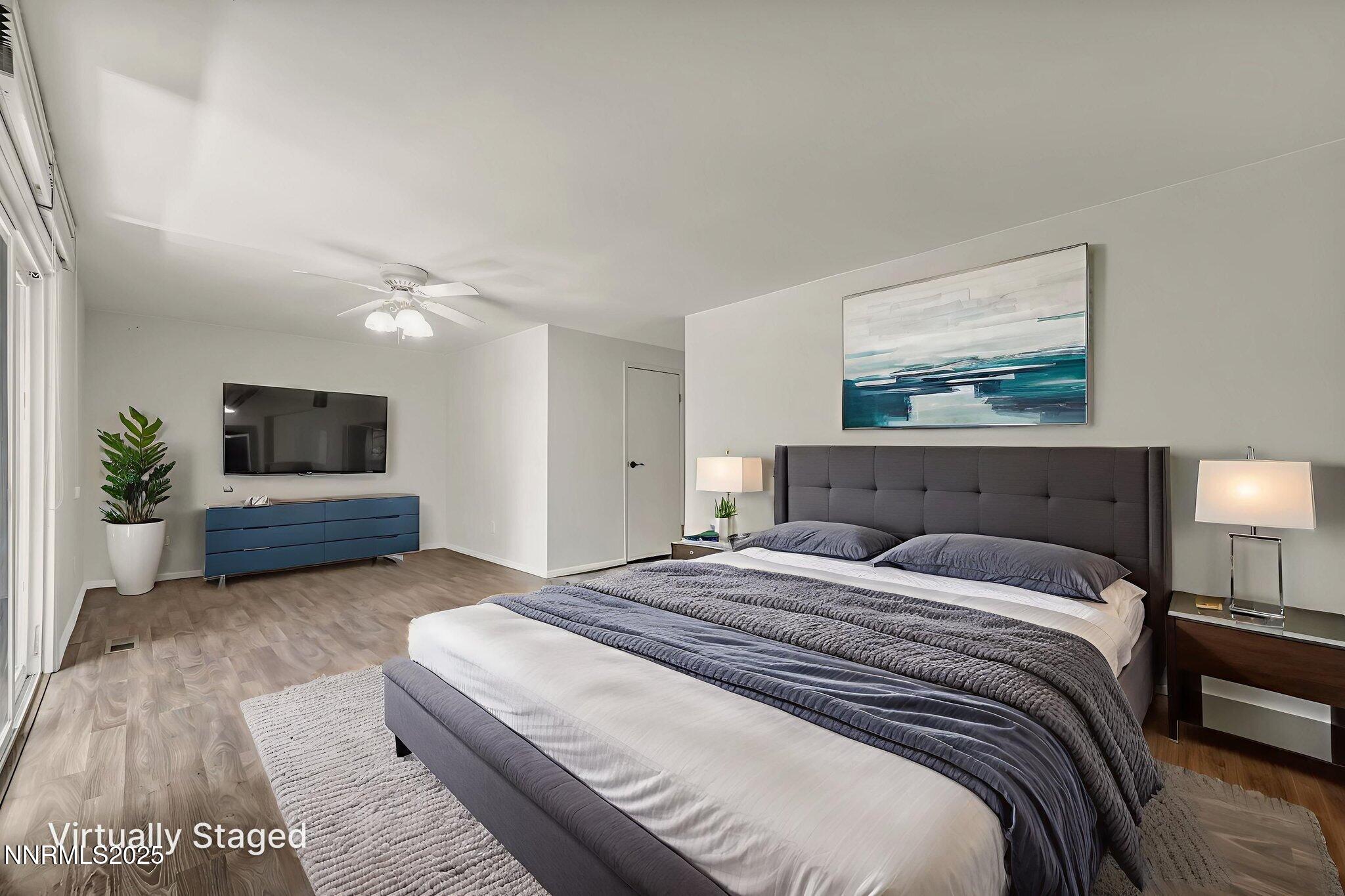 1481 Foster Drive Reno, NV 89509 - Photo 27 of 52 a bedroom with a bed and a flat screen tv