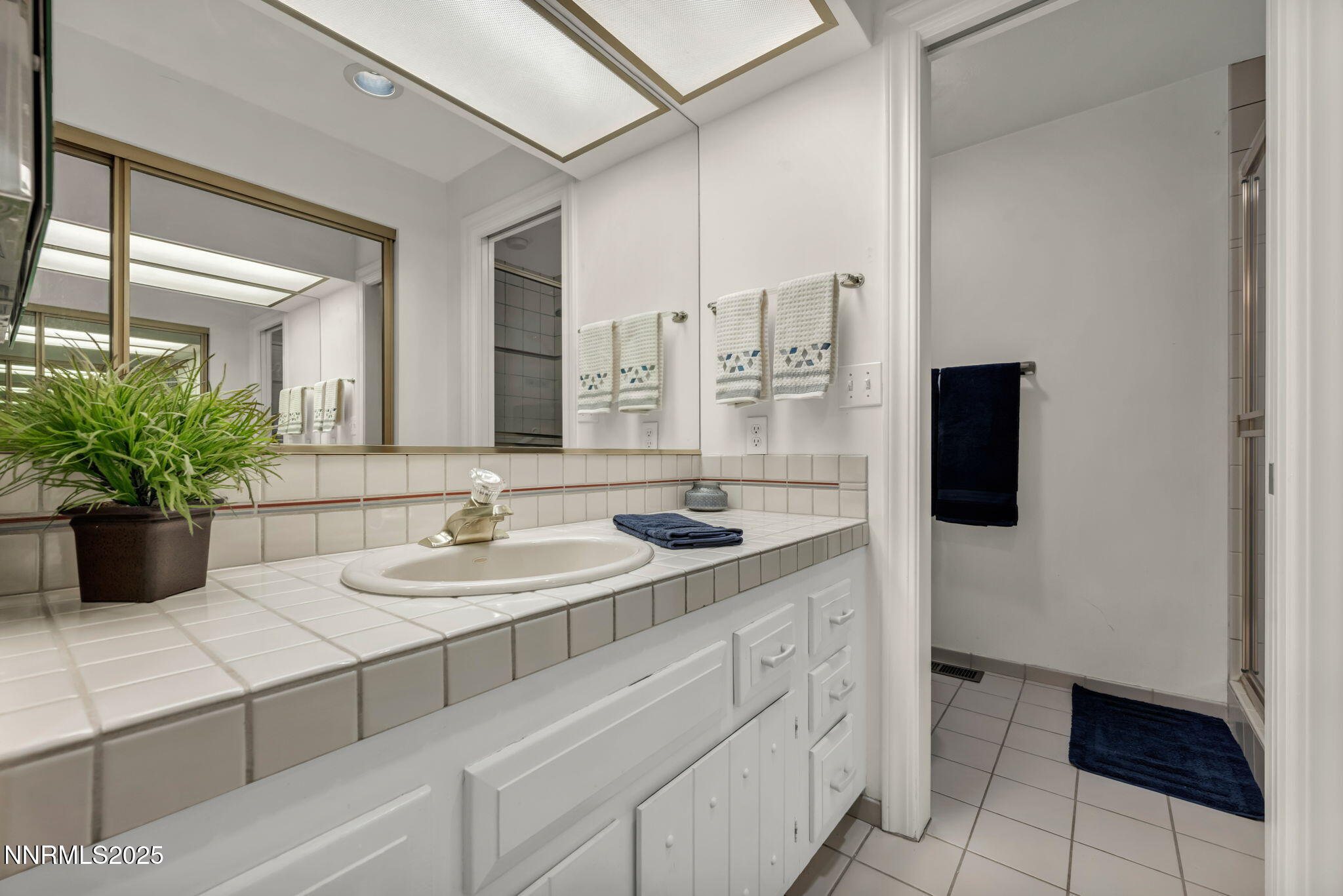 1481 Foster Drive Reno, NV 89509 - Photo 30 of 52 a bathroom with a double vanity sink and mirror
