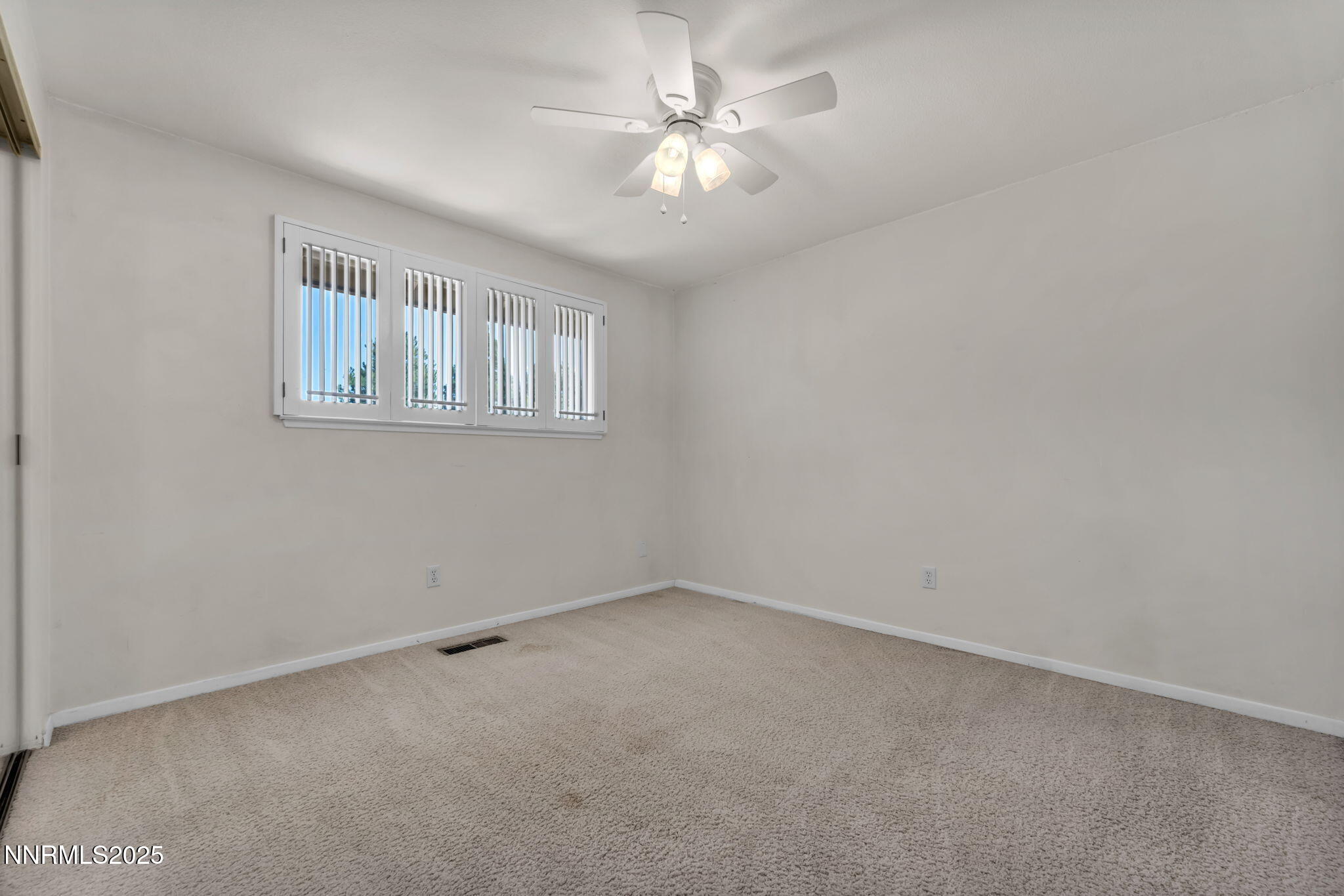 1481 Foster Drive Reno, NV 89509 - Photo 38 of 52 en empty room with windows and ceiling fan