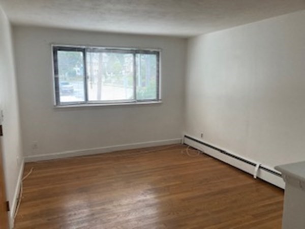 2 Winthrop Street, Unit 3 Watertown, MA 02472 - Photo 3 of 8 a view of a room with wooden floor and window