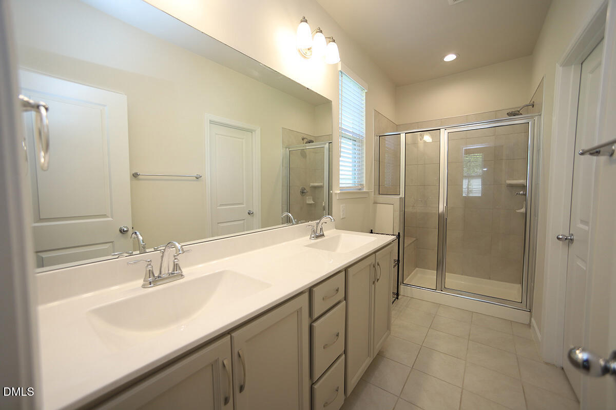 125 Mae Court Roxboro, NC 27573 - Photo 19 of 30 a bathroom with a sink double vanity and a shower