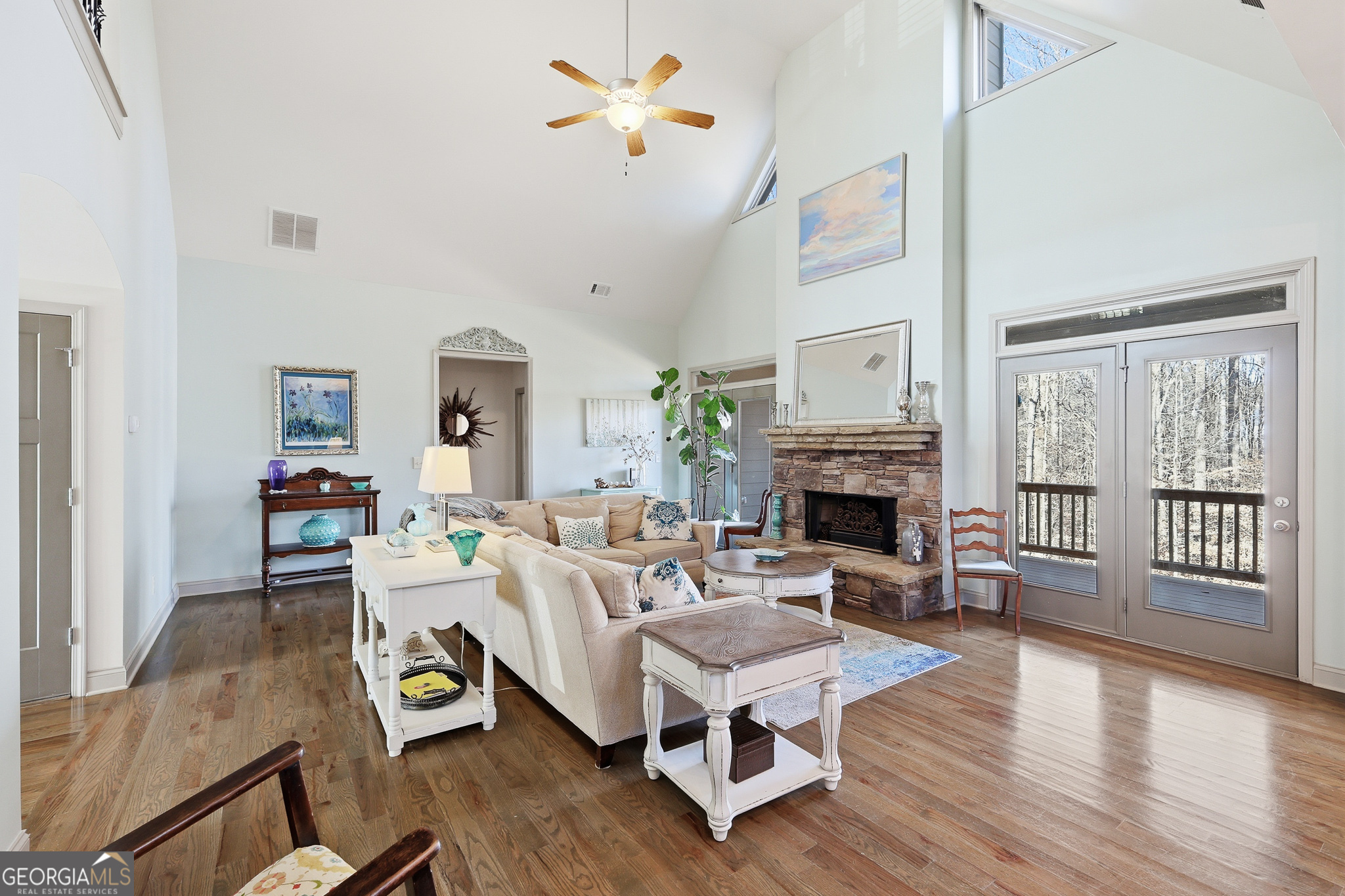56 Creek Side Court Jefferson, GA 30549 - Photo 12 of 46 a living room with furniture a fireplace and a floor to ceiling window