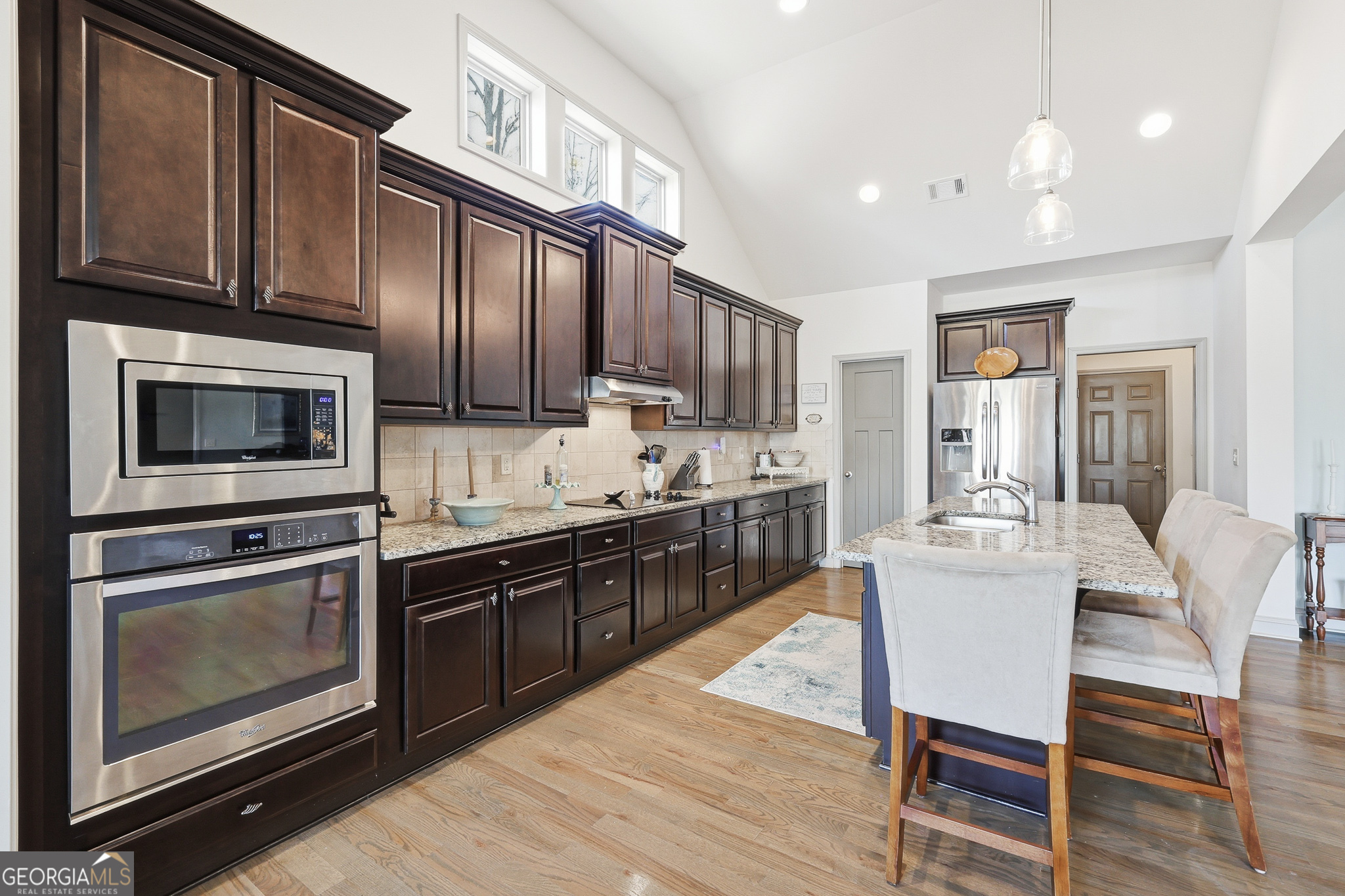 56 Creek Side Court Jefferson, GA 30549 - Photo 20 of 46 a kitchen with stainless steel appliances granite countertop wooden cabinets a stove top oven a sink and dishwasher