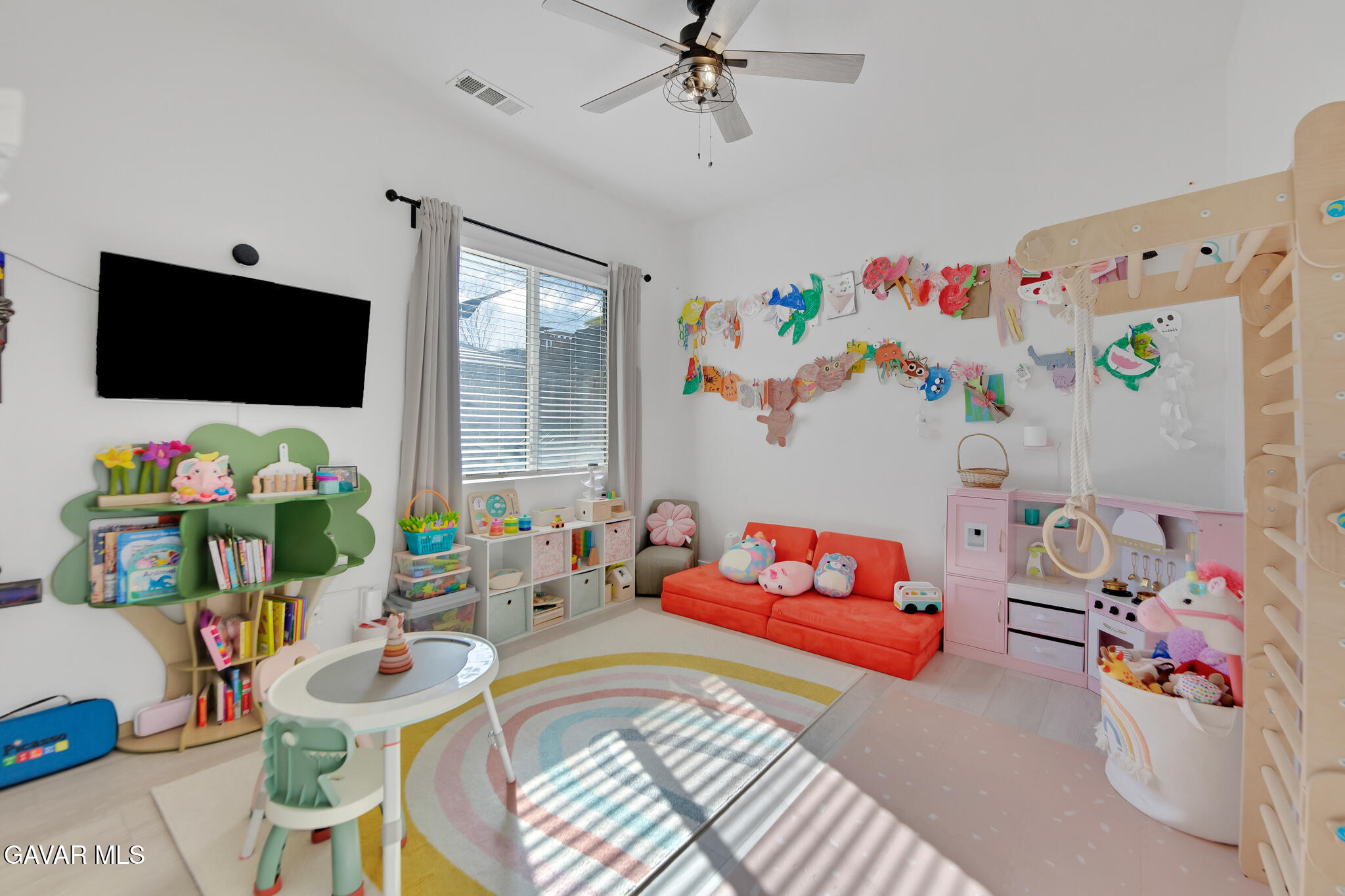 41632 Firenze Street Lancaster, CA 93536 - Photo 23 of 67 a living room with furniture and a flat screen tv