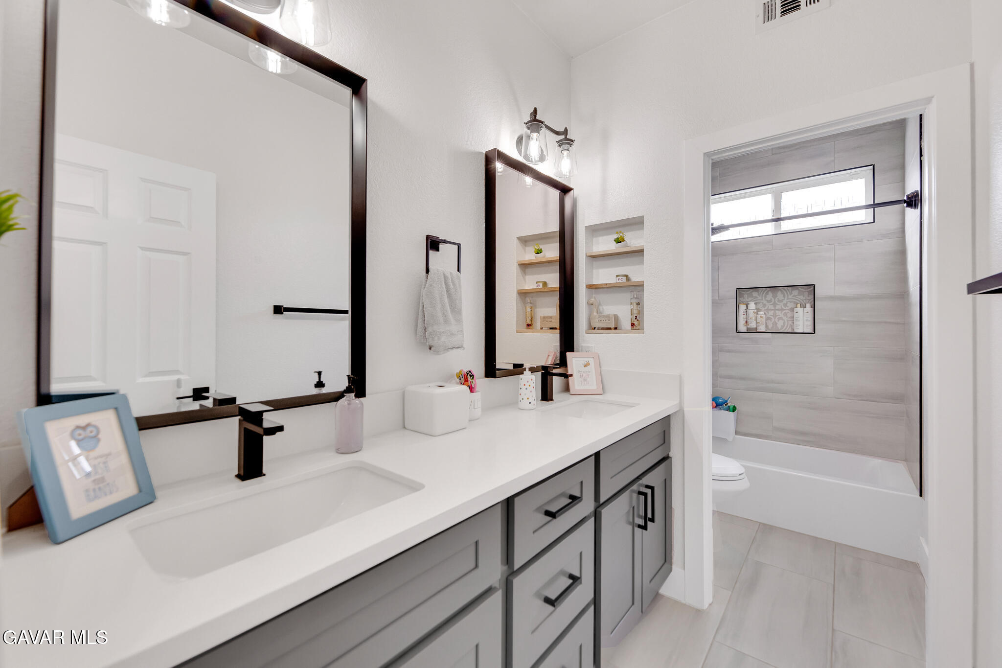 41632 Firenze Street Lancaster, CA 93536 - Photo 24 of 67 a bathroom with a sink and a mirror with bathtub