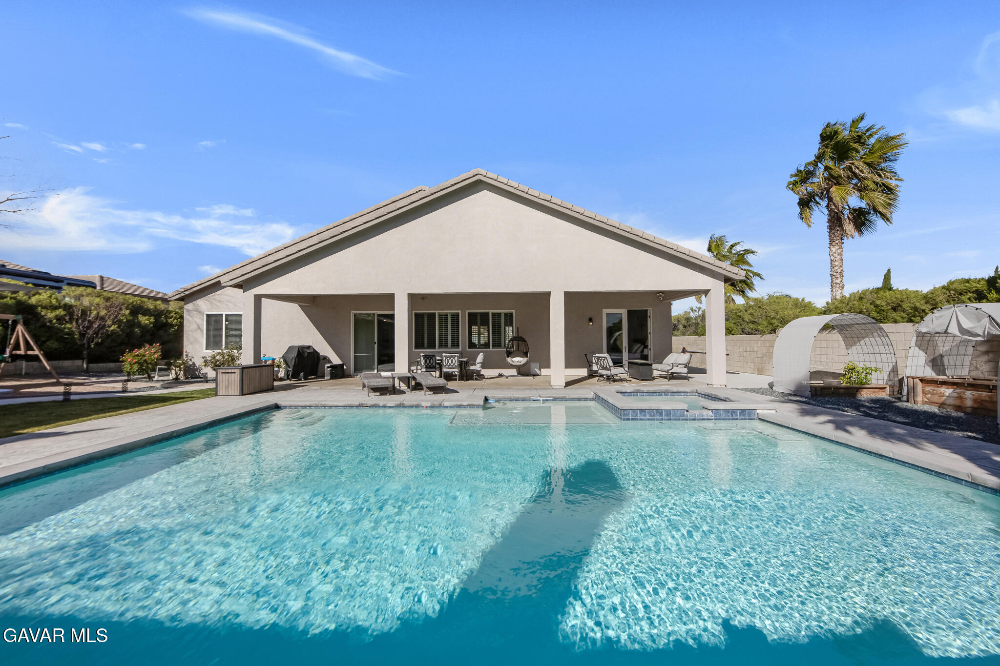 41632 Firenze Street Lancaster, CA 93536 - Photo 43 of 67 a front view of a house with swimming pool having outdoor seating