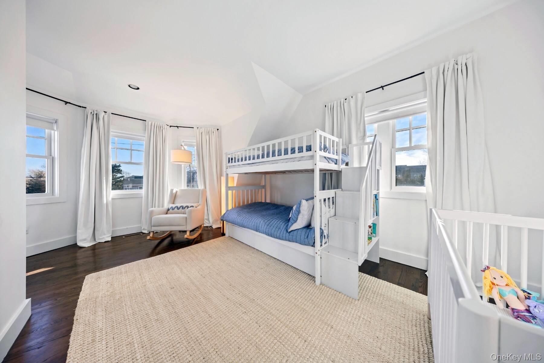 30 Exchange Place Westhampton Beach, NY 11978 - Photo 19 of 25 a bedroom with a bed and a window