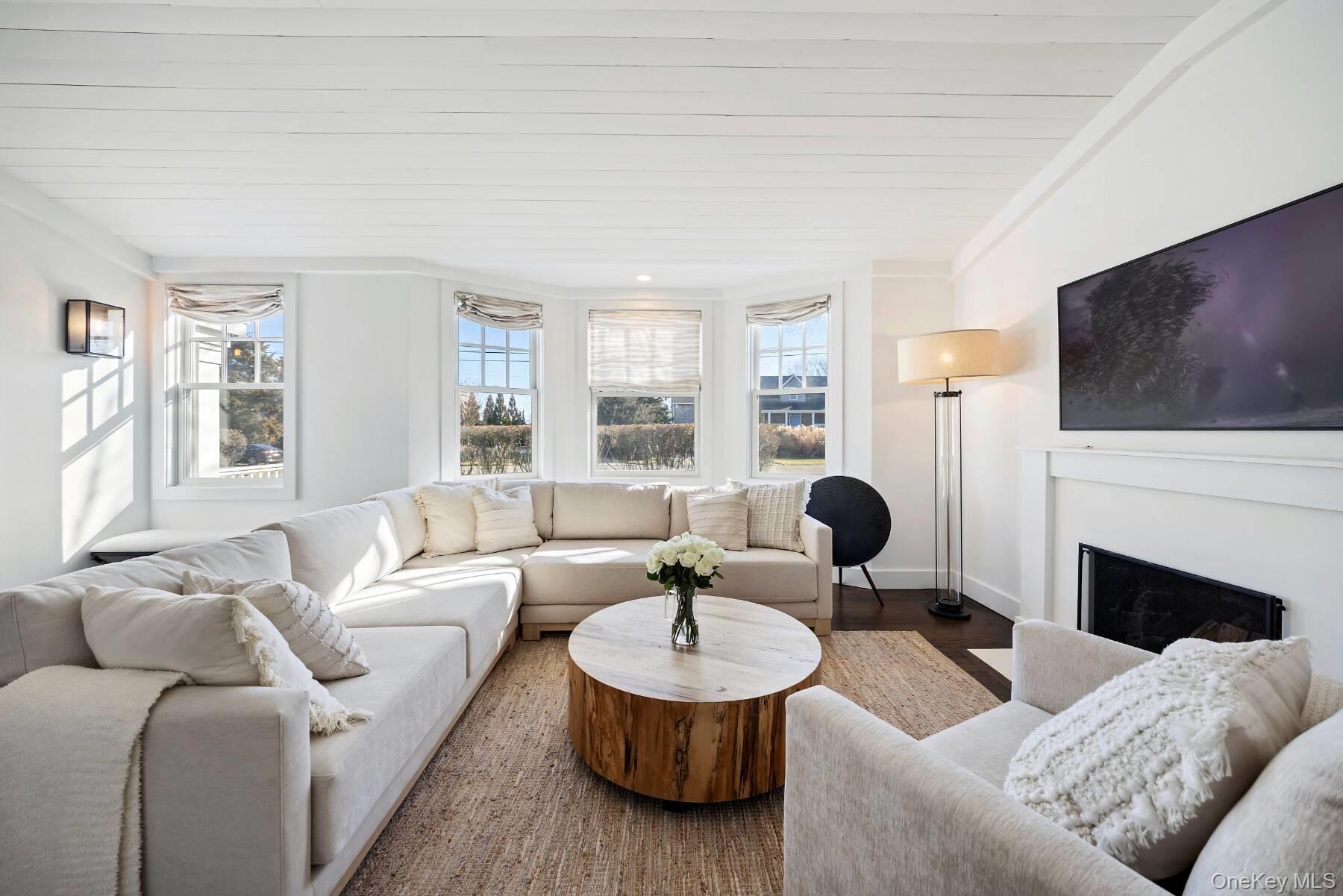 30 Exchange Place Westhampton Beach, NY 11978 - Photo 5 of 25 a living room with furniture a fireplace and a flat screen tv