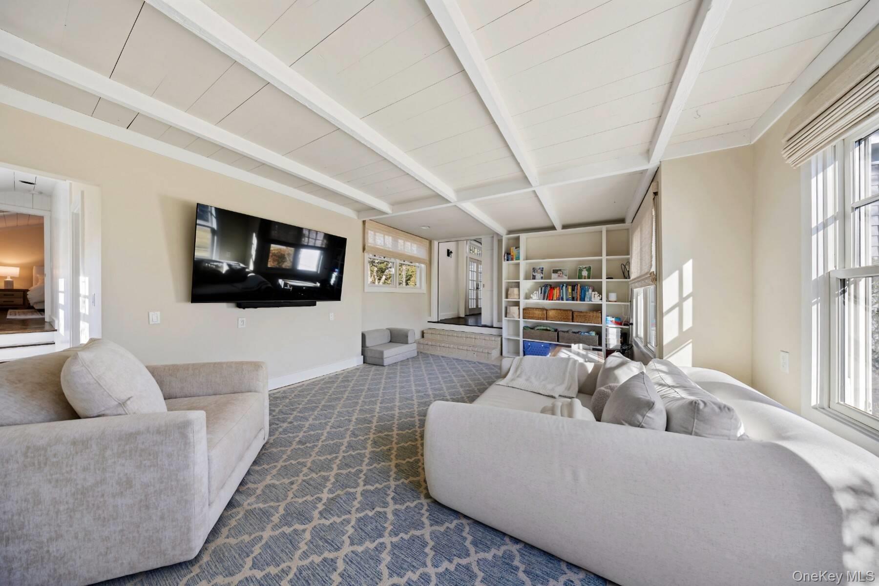 30 Exchange Place Westhampton Beach, NY 11978 - Photo 8 of 25 a living room with furniture and a flat screen tv