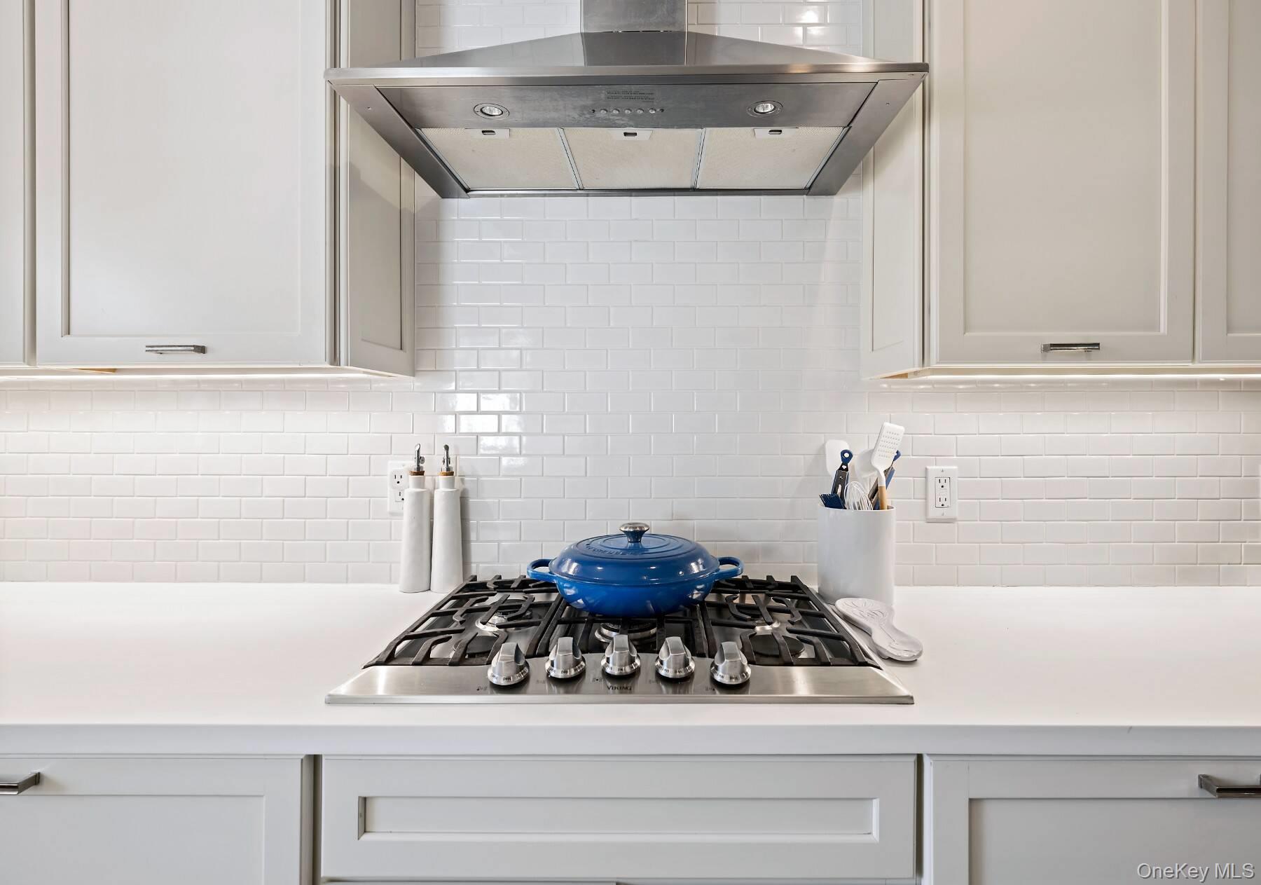 30 Exchange Place Westhampton Beach, NY 11978 - Photo 10 of 25 a kitchen with a stove and cabinets