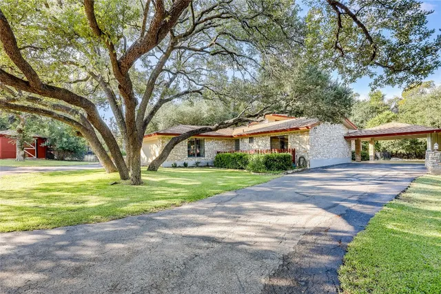 a front view of house with yard and green space