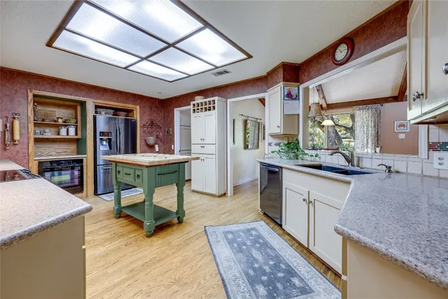 a kitchen with stainless steel appliances granite countertop sink stove and wooden cabinets