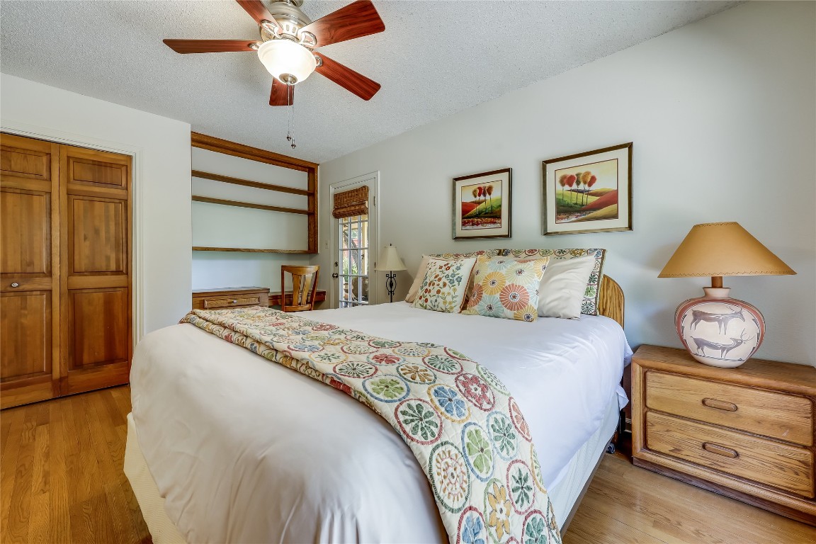 6015 Tonkowa Trail Georgetown, TX 78628 - Photo 17 of 40 a bedroom with a bed and wooden floor