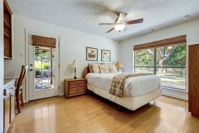 a bedroom with a large bed and a chandelier