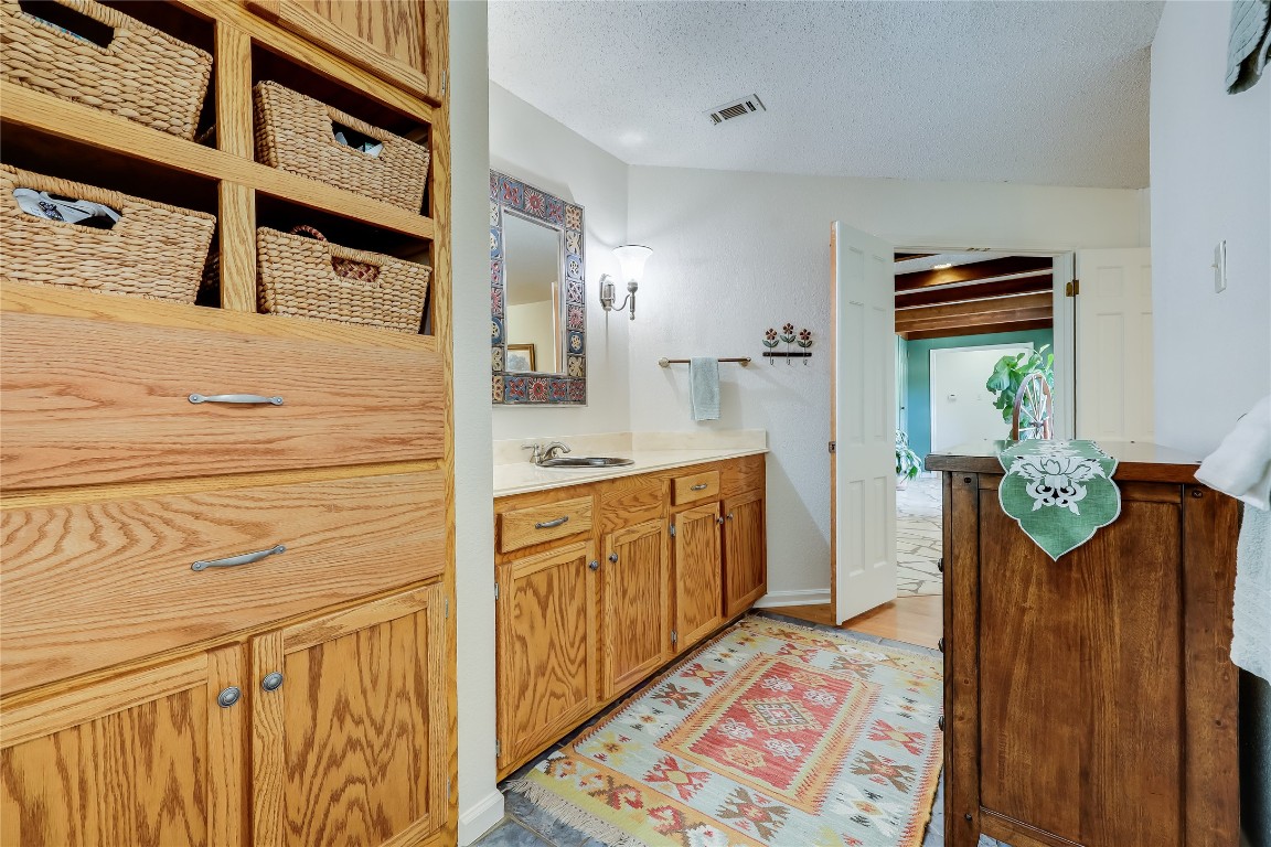 6015 Tonkowa Trail Georgetown, TX 78628 - Photo 22 of 40 a bathroom with a sink a mirror and a shower