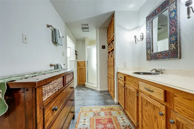 a bathroom with a sink a mirror and a shower