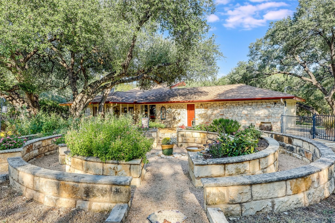 6015 Tonkowa Trail Georgetown, TX 78628 - Photo 30 of 40 a view of a house with a yard plants and large tree