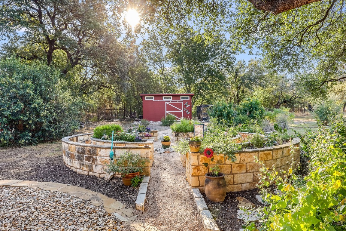 6015 Tonkowa Trail Georgetown, TX 78628 - Photo 35 of 40 a view of a back yard of the house and a garden