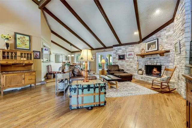 a living room with fireplace furniture and a wooden floor