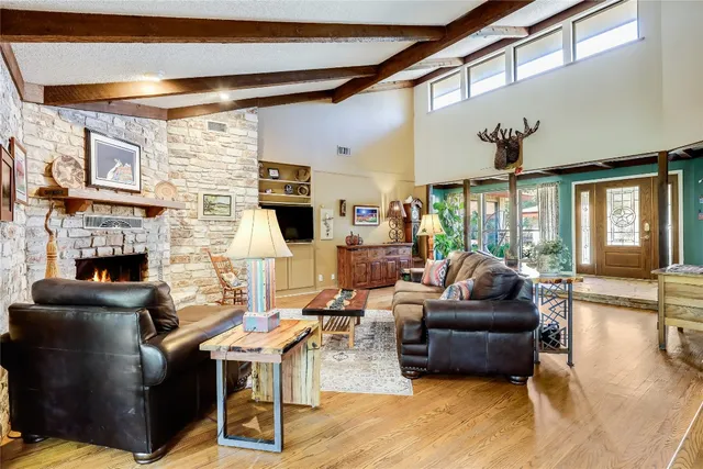 a living room with fireplace furniture and a flat screen tv