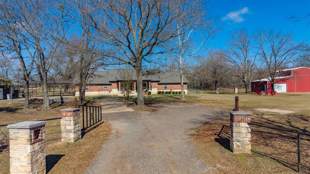 24 County Rd NW 1060 Talco, TX 75487 - Photo 4 of 40 a view of a yard with wooden fence