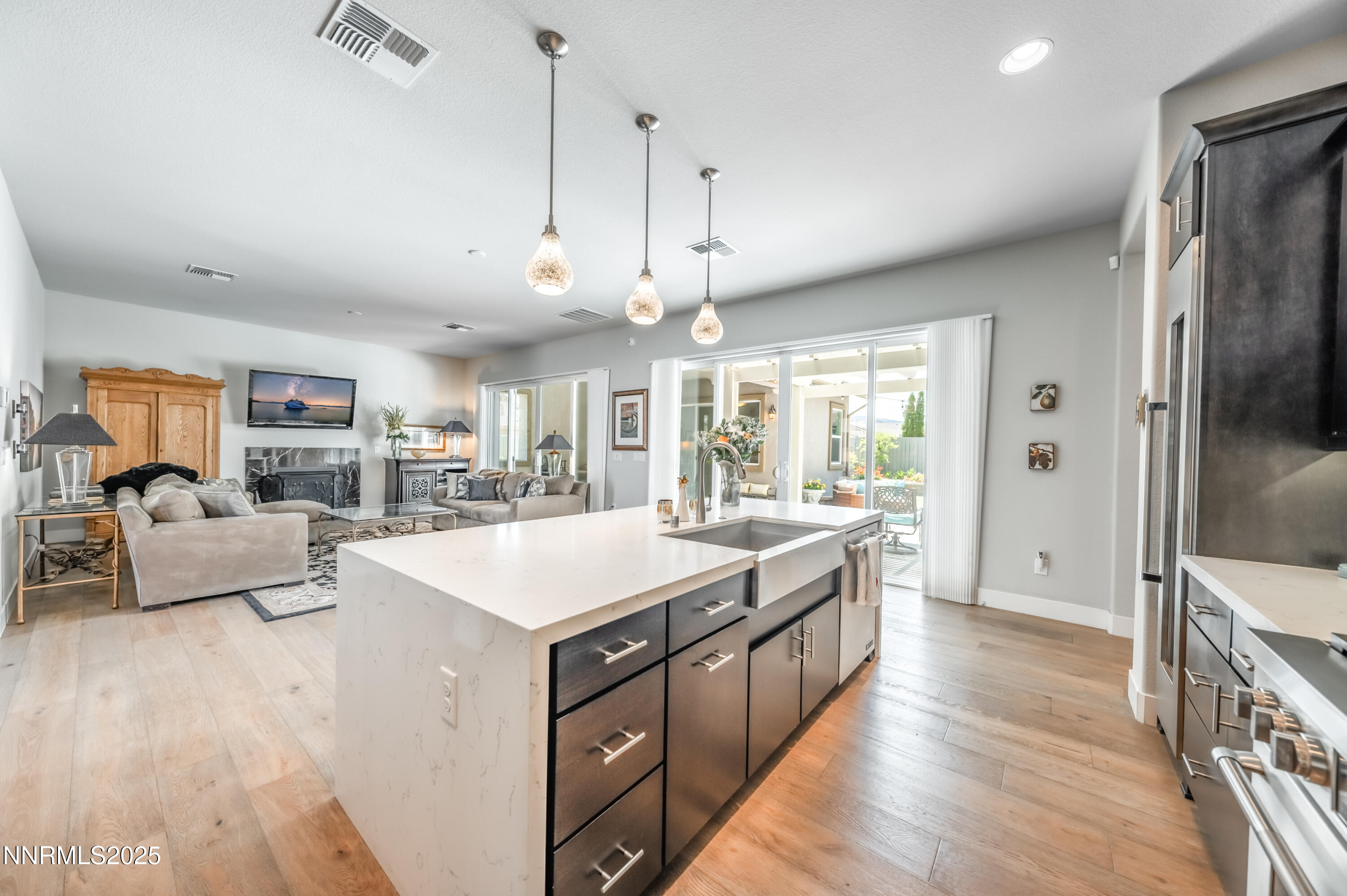 2300 Brego Lane Reno, NV 89521 - Photo 14 of 69 a large kitchen with kitchen island a large counter space a sink appliances and a chandelier