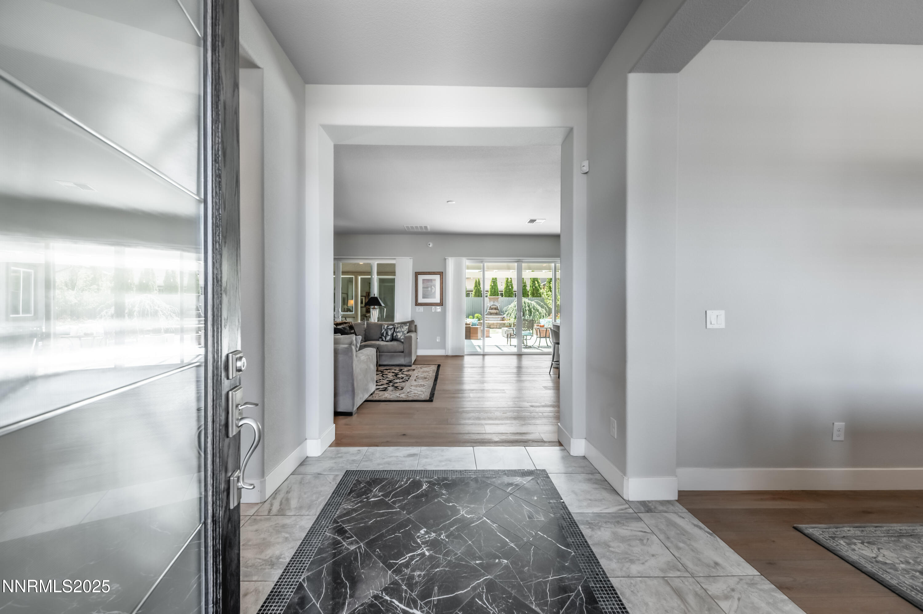 2300 Brego Lane Reno, NV 89521 - Photo 5 of 69 a view of a hallway to a livingroom with wooden floor and furniture
