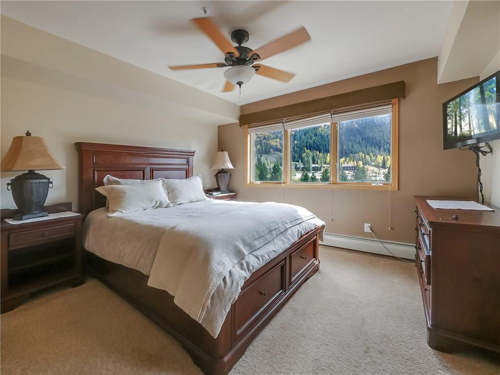 72 Oro Grande Road, Unit 212 Keystone, CO 80435 - Photo 18 of 21 a spacious bedroom with a bed and a ceiling fan