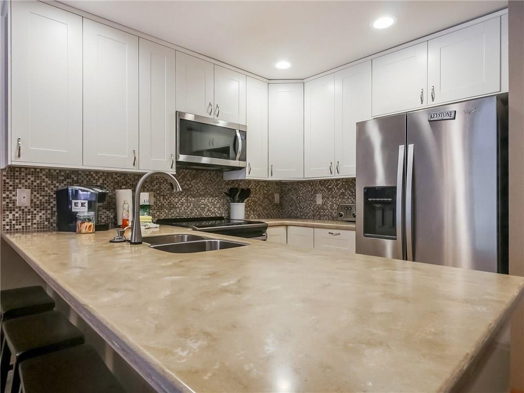 72 Oro Grande Road, Unit 212 Keystone, CO 80435 - Photo 5 of 21 a kitchen with granite countertop a refrigerator a stove a sink a counter top space and cabinets