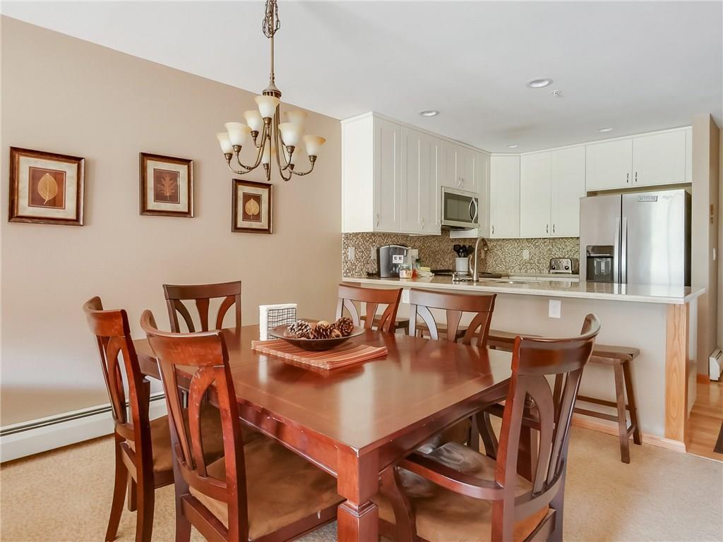 72 Oro Grande Road, Unit 212 Keystone, CO 80435 - Photo 7 of 21 a dining room with stainless steel appliances kitchen island granite countertop a dining table and chairs