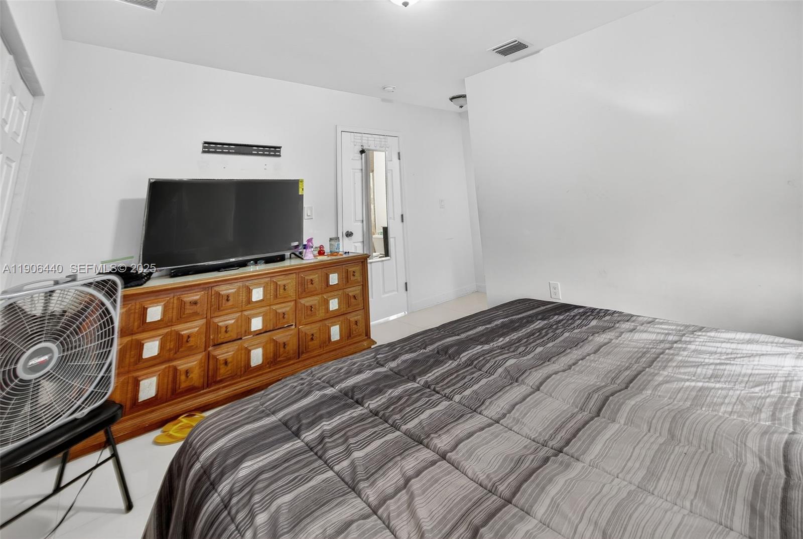 344 Southwest 3rd Street Florida City, FL 33034 - Photo 12 of 35 a bedroom with a bed and a flat screen tv