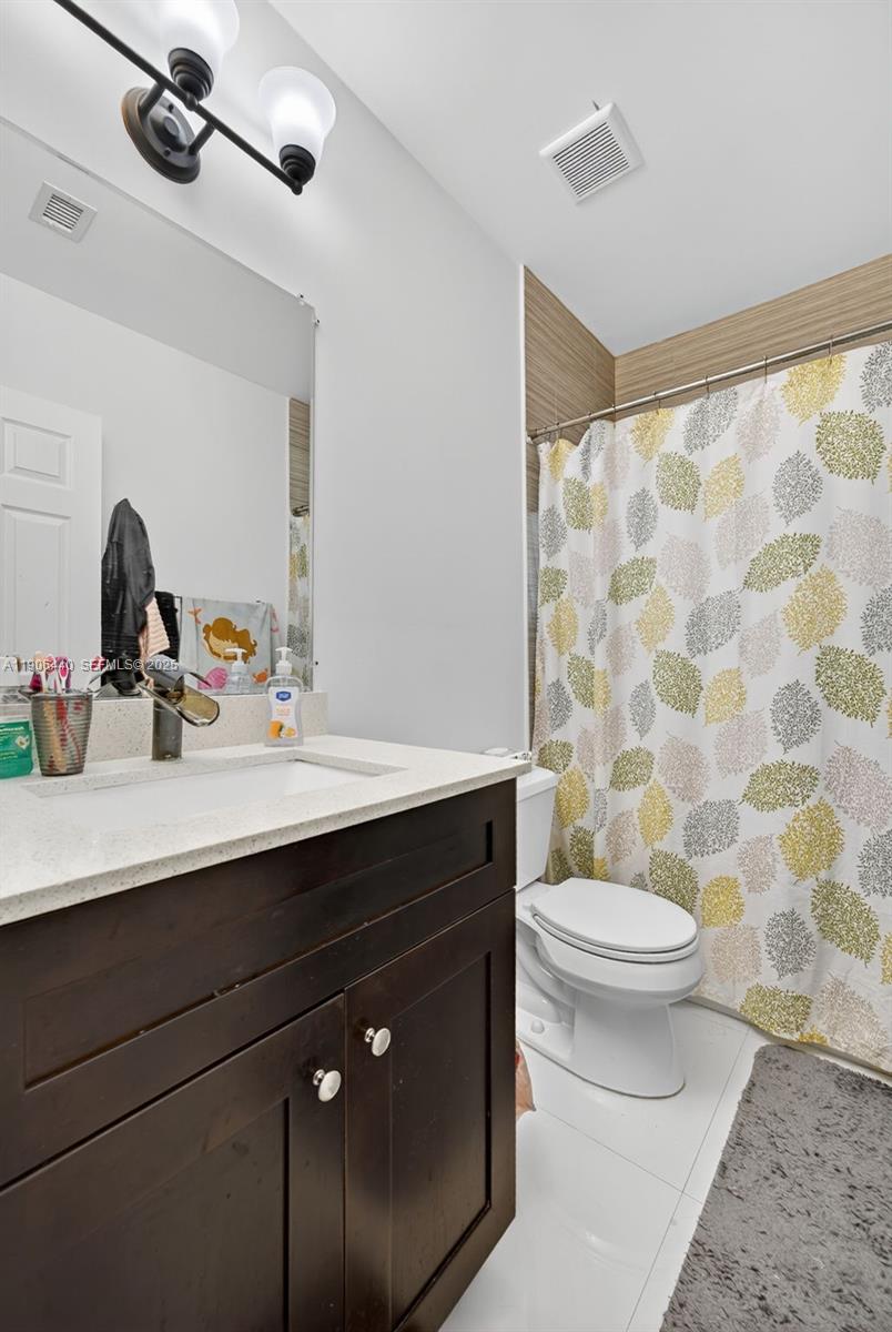 344 Southwest 3rd Street Florida City, FL 33034 - Photo 14 of 35 a bathroom with a double vanity sink toilet and a mirror