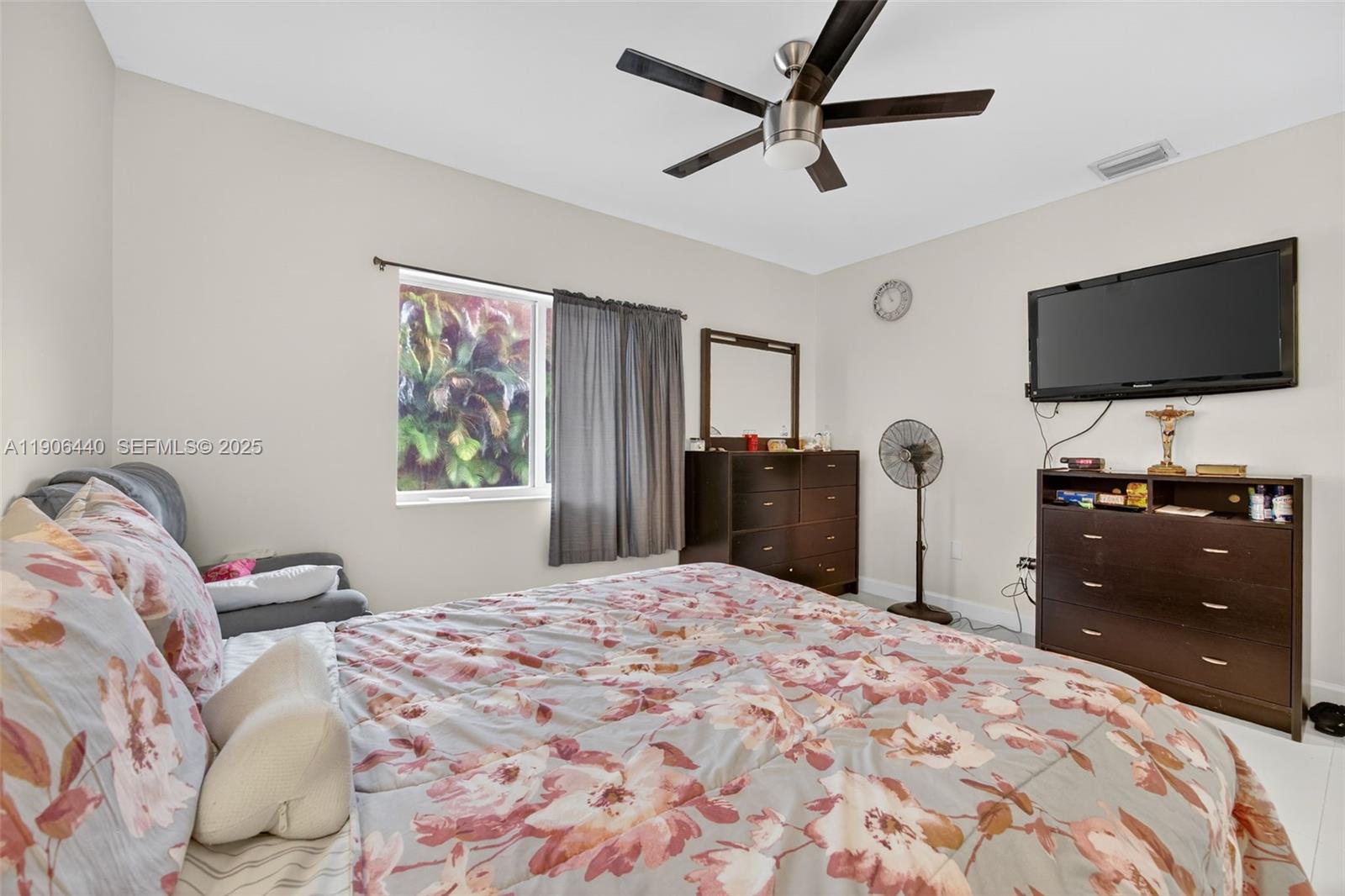 344 Southwest 3rd Street Florida City, FL 33034 - Photo 16 of 35 a bedroom with a bed and a flat screen tv