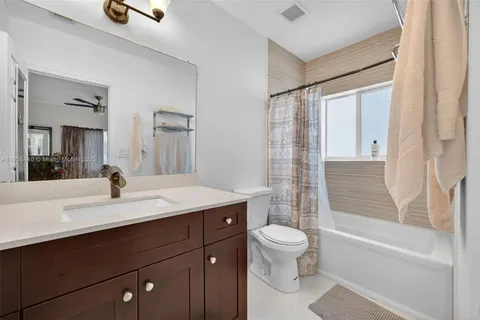 a bathroom with a sink a toilet and a tub