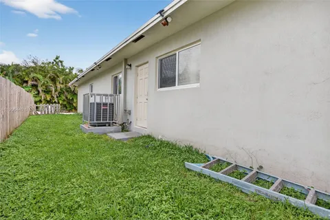 a backyard of a house with table and chairs
