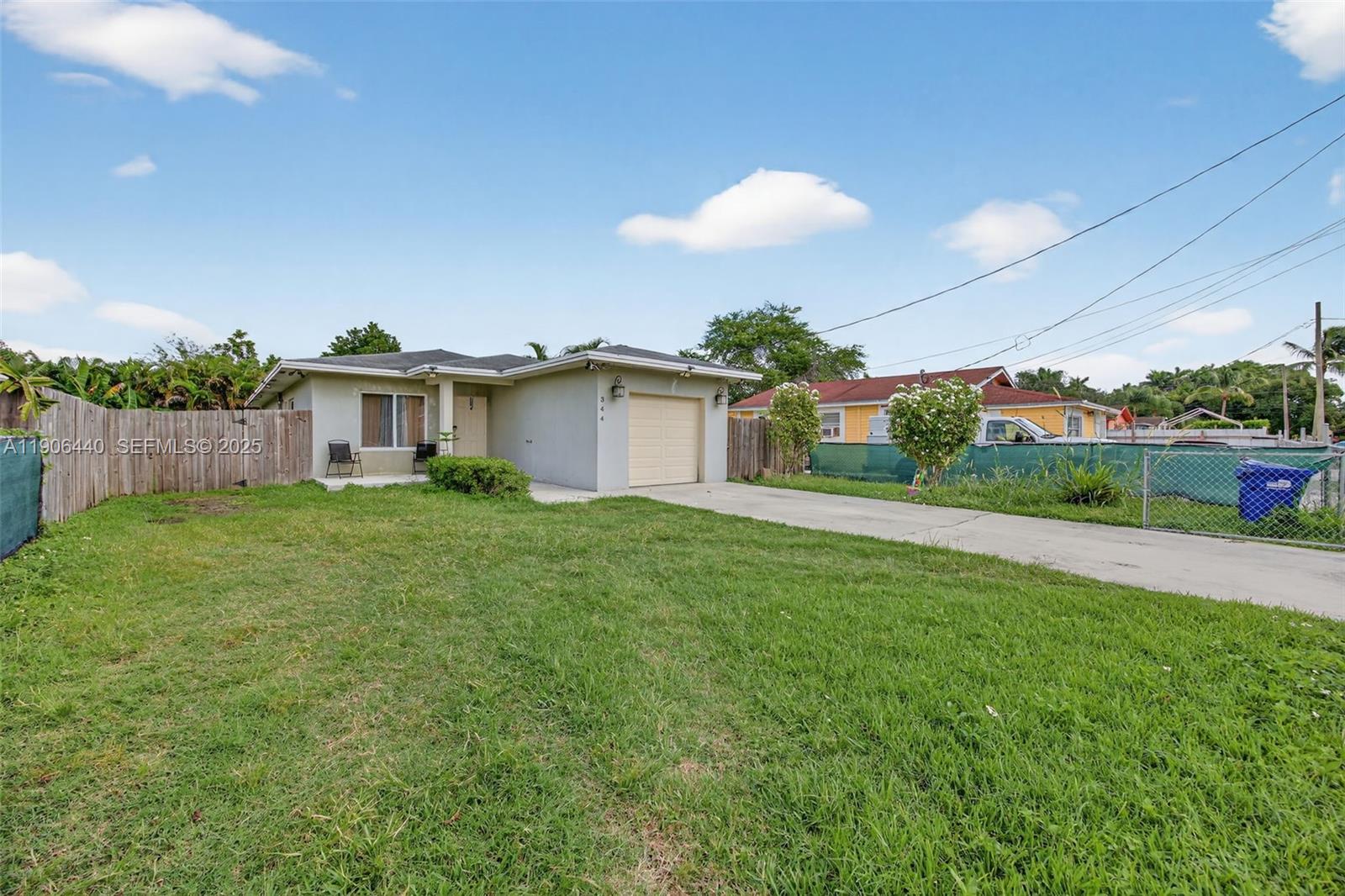 344 Southwest 3rd Street Florida City, FL 33034 - Photo 4 of 35 a view of a house with a backyard and a garden