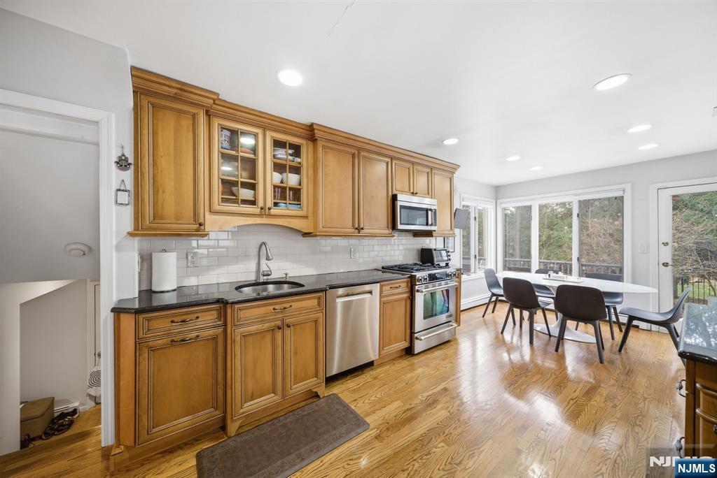 126 Sussex Road Tenafly, NJ 07670 - Photo 11 of 50 a kitchen with granite countertop lots of counter top space and dining table