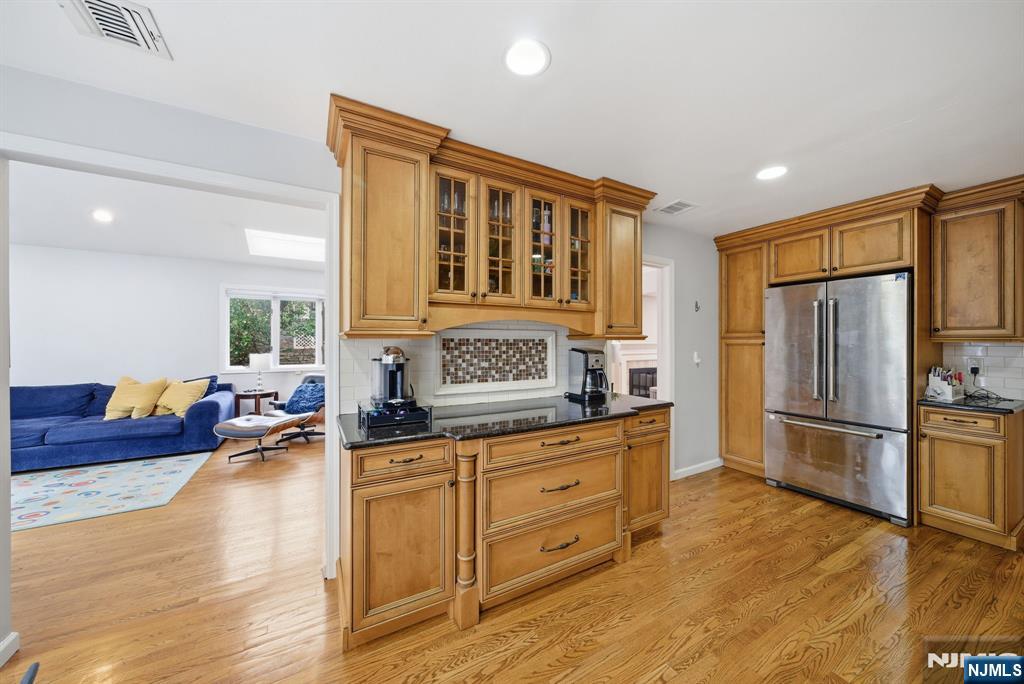 126 Sussex Road Tenafly, NJ 07670 - Photo 15 of 50 a kitchen with granite countertop a refrigerator stove top oven and cabinets