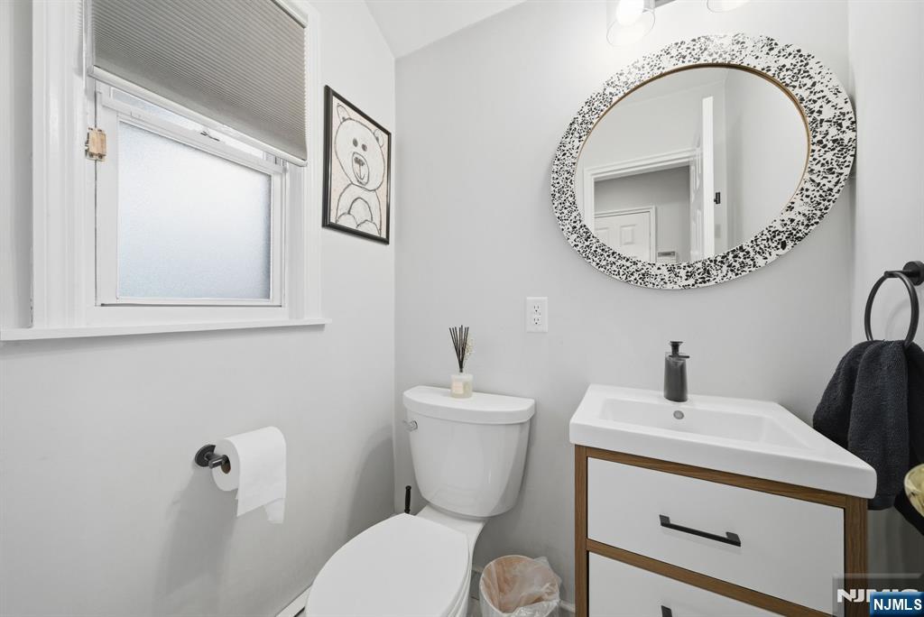 126 Sussex Road Tenafly, NJ 07670 - Photo 24 of 50 a bathroom with a toilet a sink and a mirror