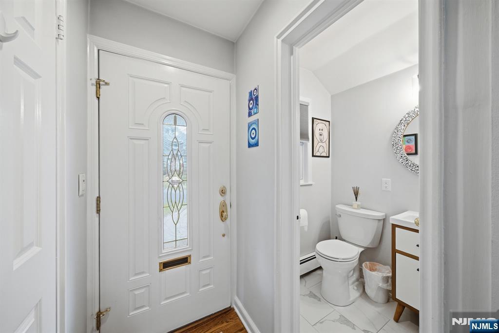 126 Sussex Road Tenafly, NJ 07670 - Photo 3 of 50 a white toilet sitting next to a bathroom sink