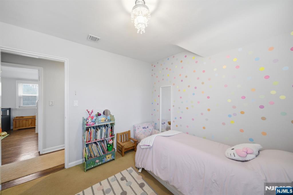 126 Sussex Road Tenafly, NJ 07670 - Photo 31 of 50 a bedroom with a bed and a book shelf