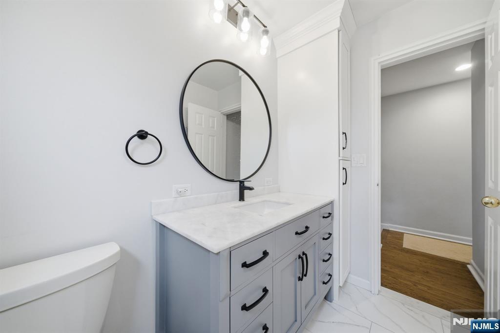 126 Sussex Road Tenafly, NJ 07670 - Photo 34 of 50 a bathroom with a granite countertop sink and a mirror