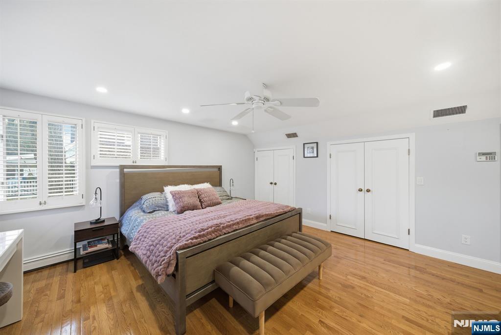126 Sussex Road Tenafly, NJ 07670 - Photo 37 of 50 a bedroom with a bed and wooden floor