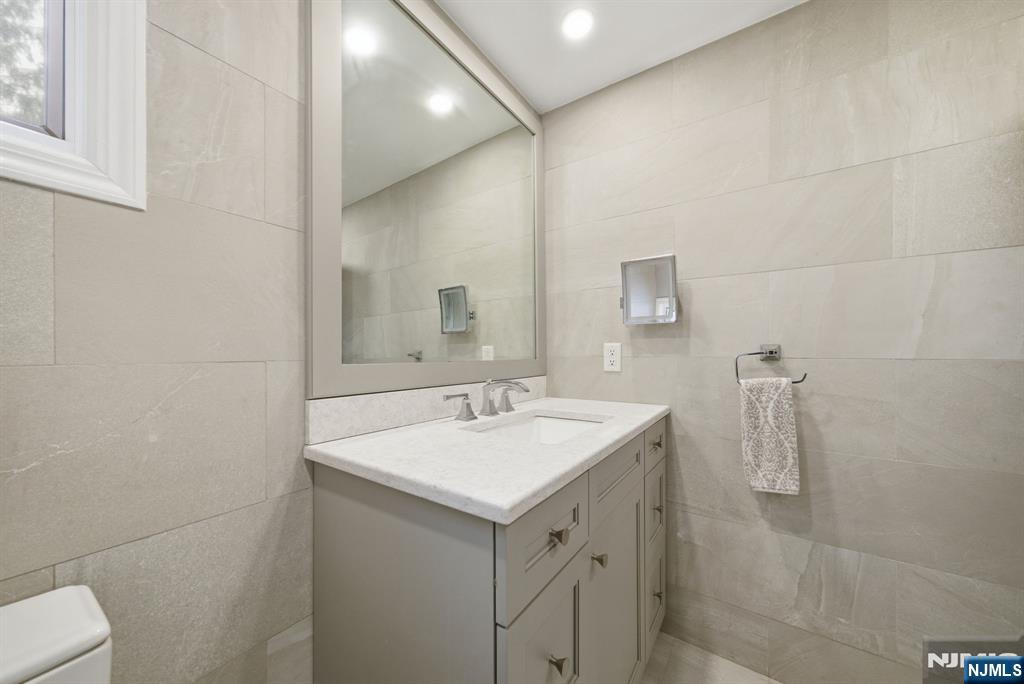 126 Sussex Road Tenafly, NJ 07670 - Photo 40 of 50 a bathroom with a sink and mirror