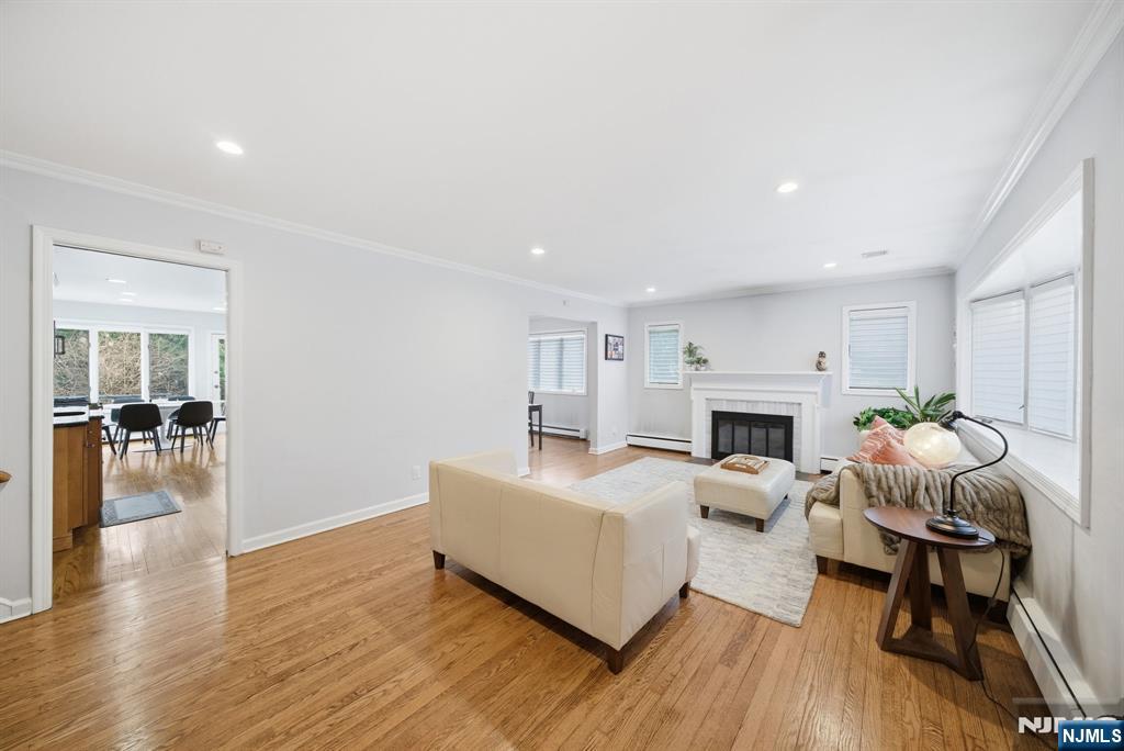 126 Sussex Road Tenafly, NJ 07670 - Photo 4 of 50 a living room with furniture a fireplace and a table