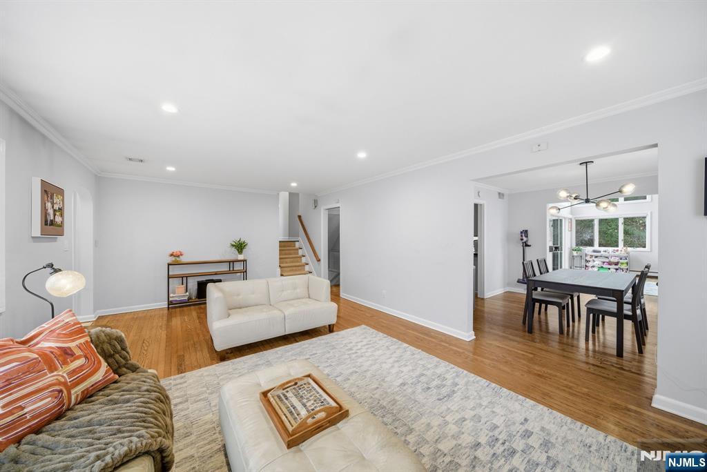 126 Sussex Road Tenafly, NJ 07670 - Photo 9 of 50 a living room with furniture and a dining table with wooden floor